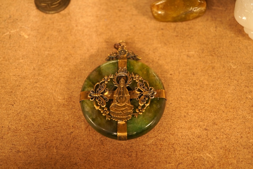 Chinese items comprising a soapstone carving, three jade carvings, one with gilt metal pendant mounts and two brass knops